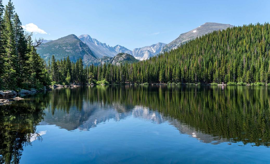 Nature scene of a lake with mountains in the background