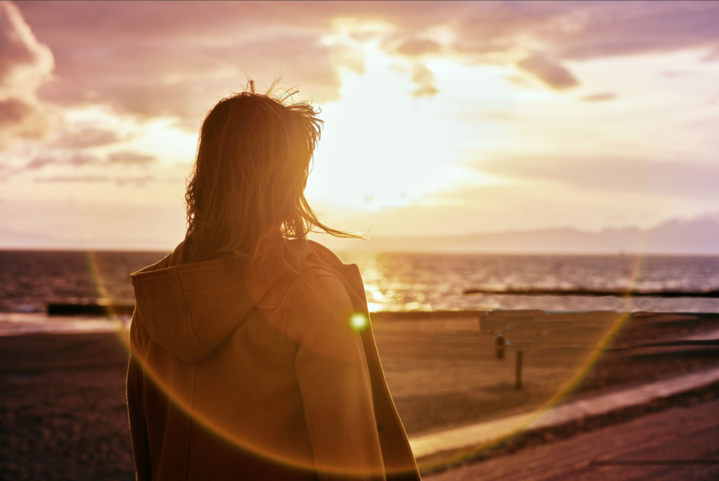 Woman looking into sunset