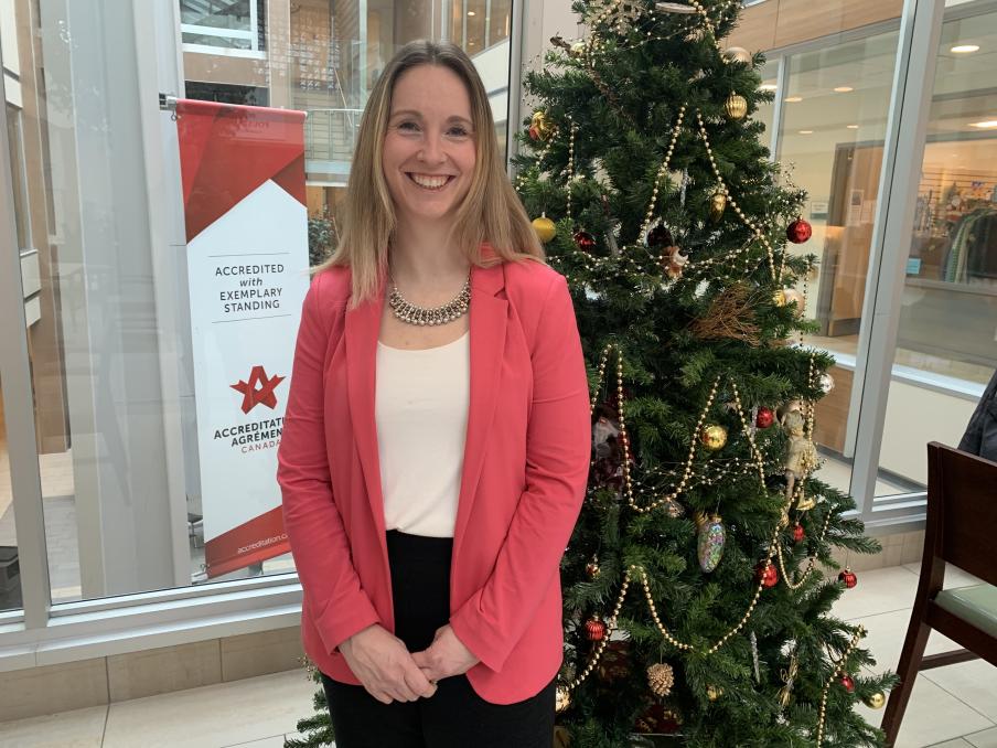 Jillian Crabbe standing in front of a Christmas tree