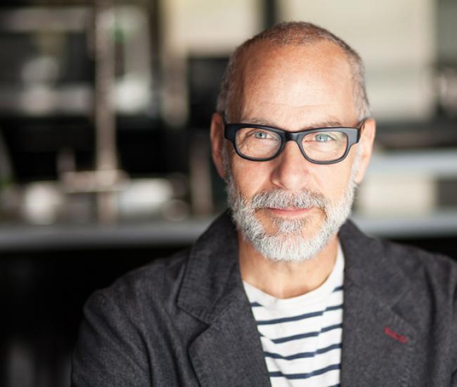 Man looking ahead into camera with slight smile