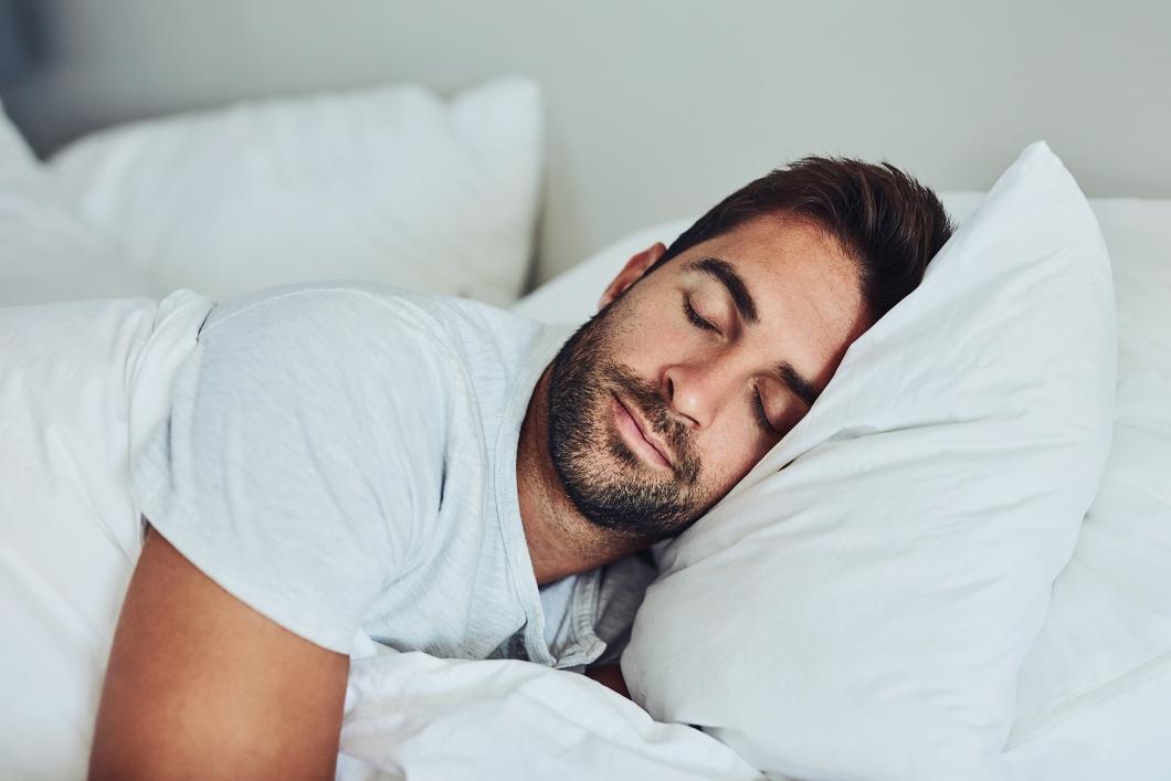 Man sleeping with head on pillow