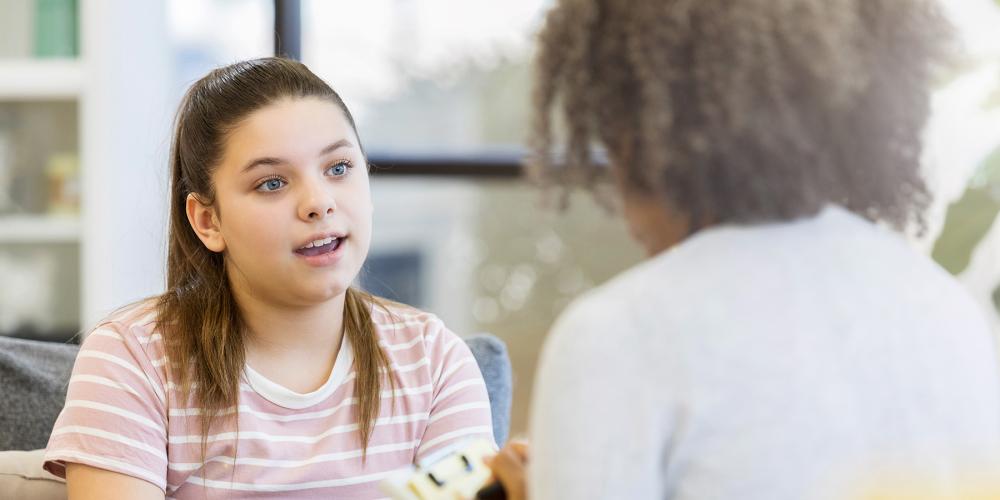 Young girl speaking to therapist