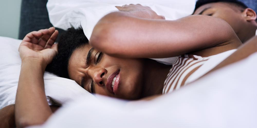 Woman having a restless sleep