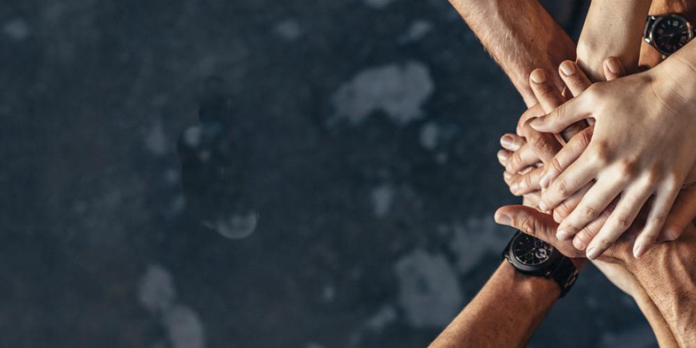 Hands on top of one another