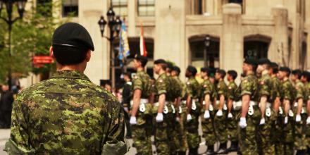 Canadian military members stand in formation. 