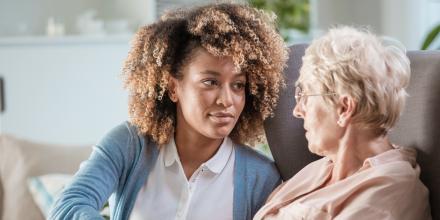 A mental health worker with a senior client in her home.